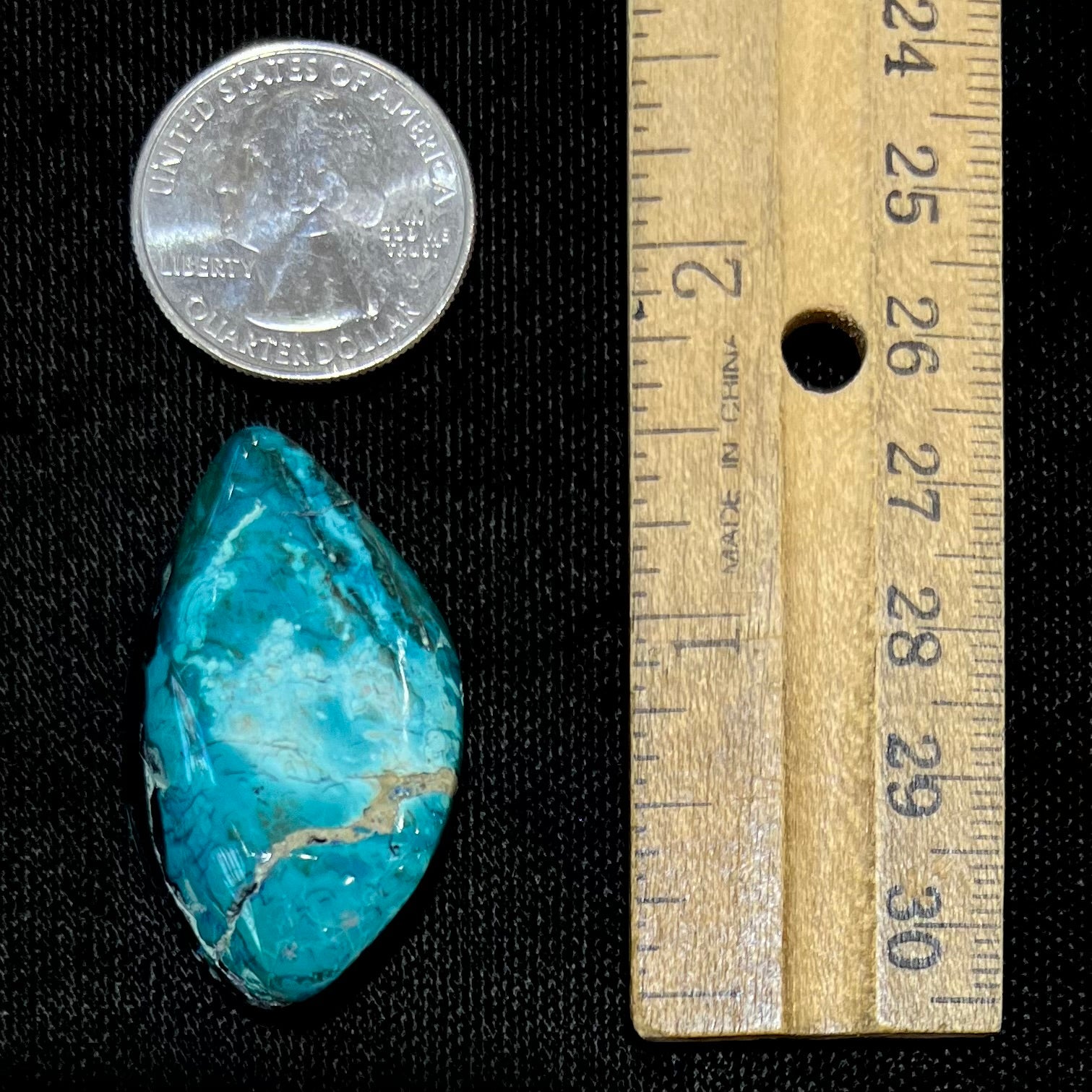 A loose chrysocolla stone with turquoise inclusions.