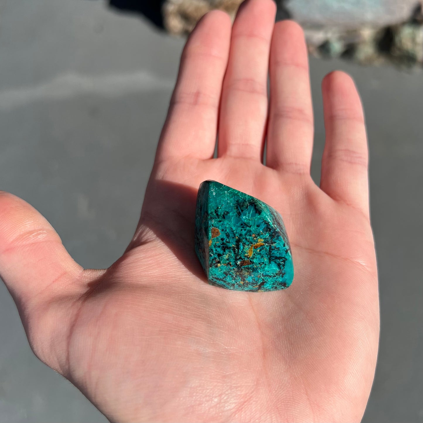 A loose polished chrysocolla specimen that has a crackled effect.