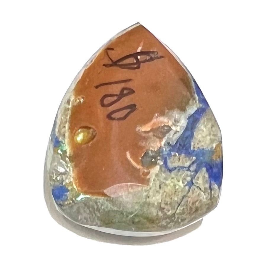 A loose pear shape cabochon cut blue azurite stone with green pseudomalachite inclusions.