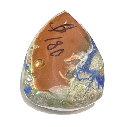 A loose pear shape cabochon cut blue azurite stone with green pseudomalachite inclusions.