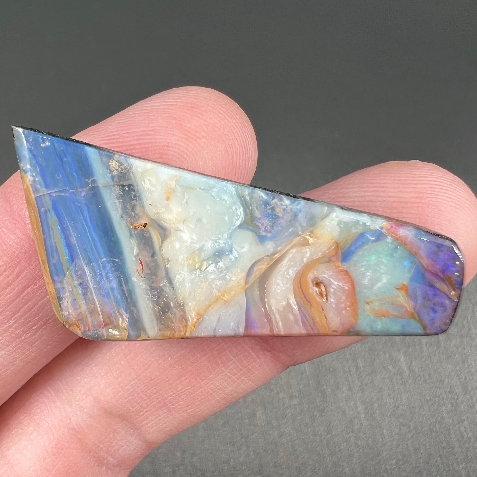 A loose, freeform cut, patterned Quilpie boulder opal stone from Queensland, Australia.