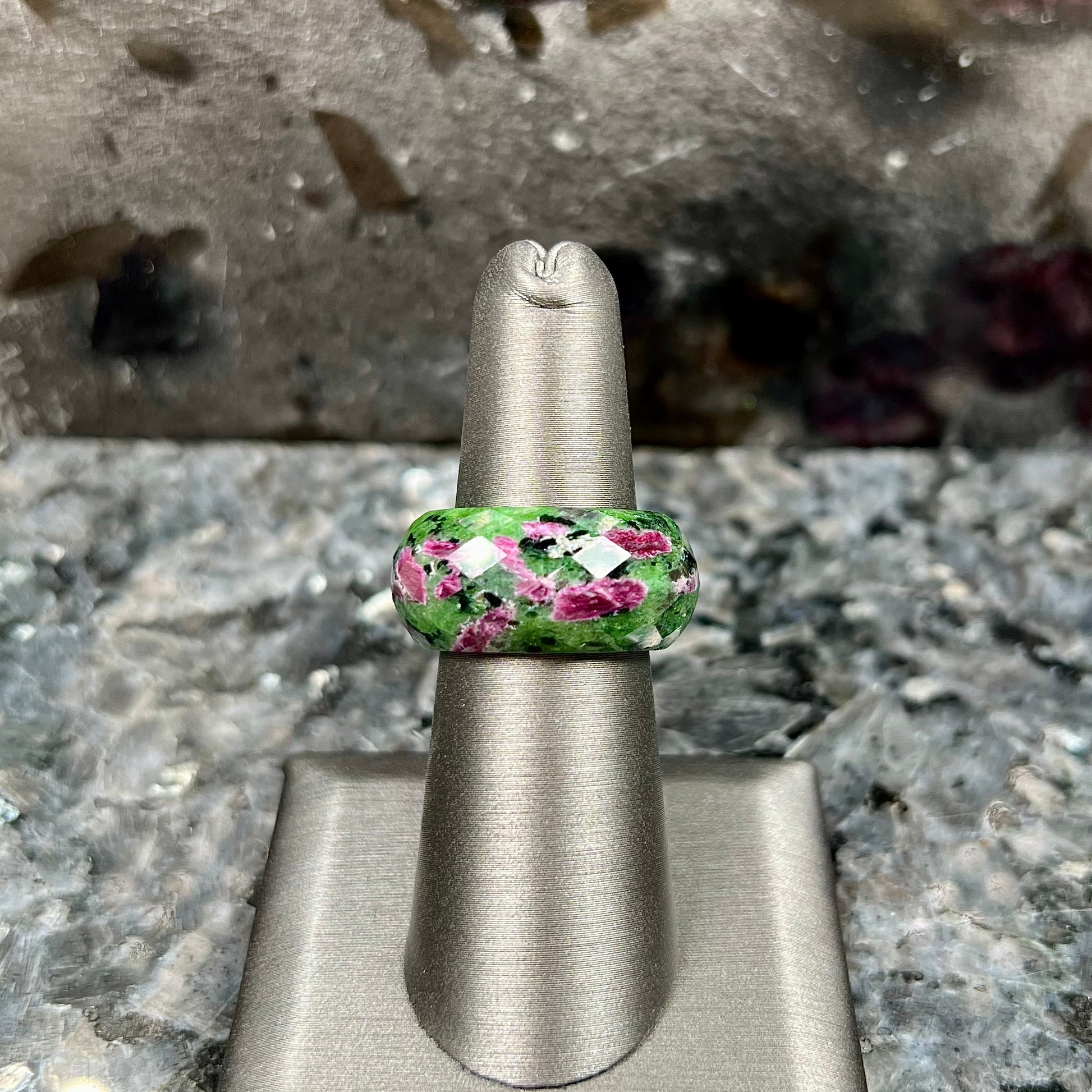 A faceted, carved stone ring made form ruby in zoisite.