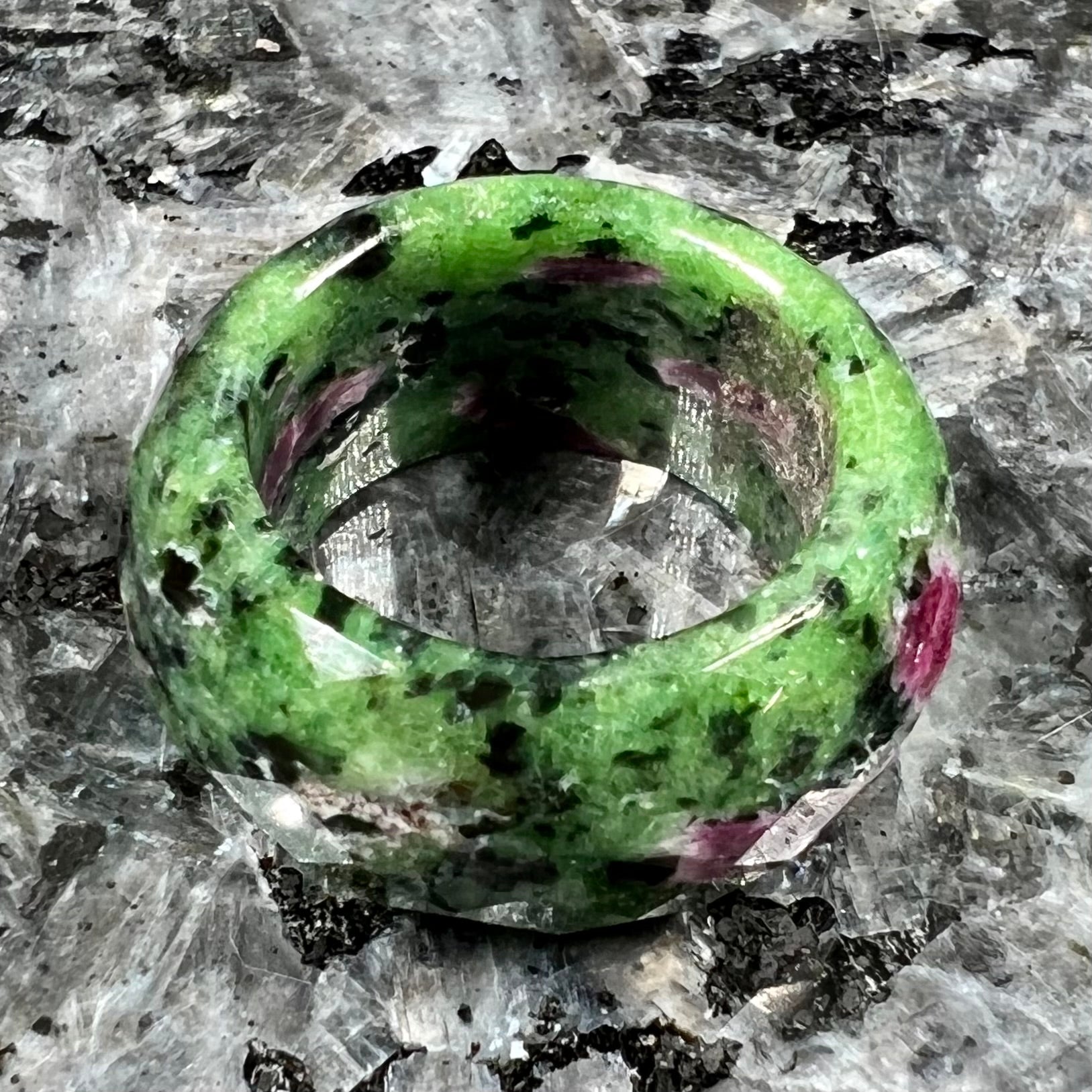 A faceted, carved stone ring made form ruby in zoisite.