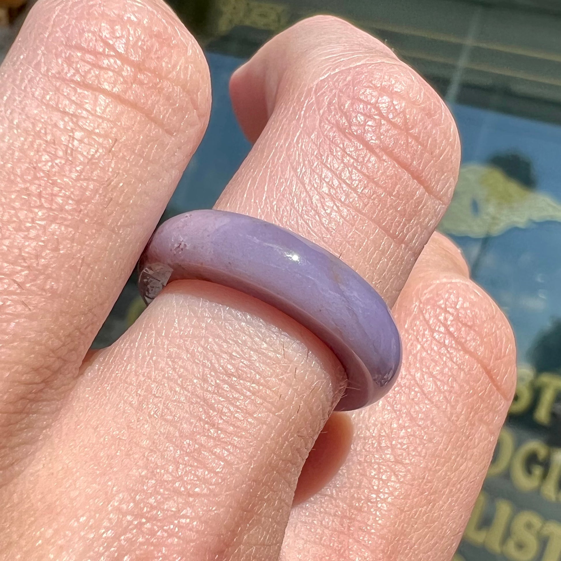 A carved lavender jade stone band.