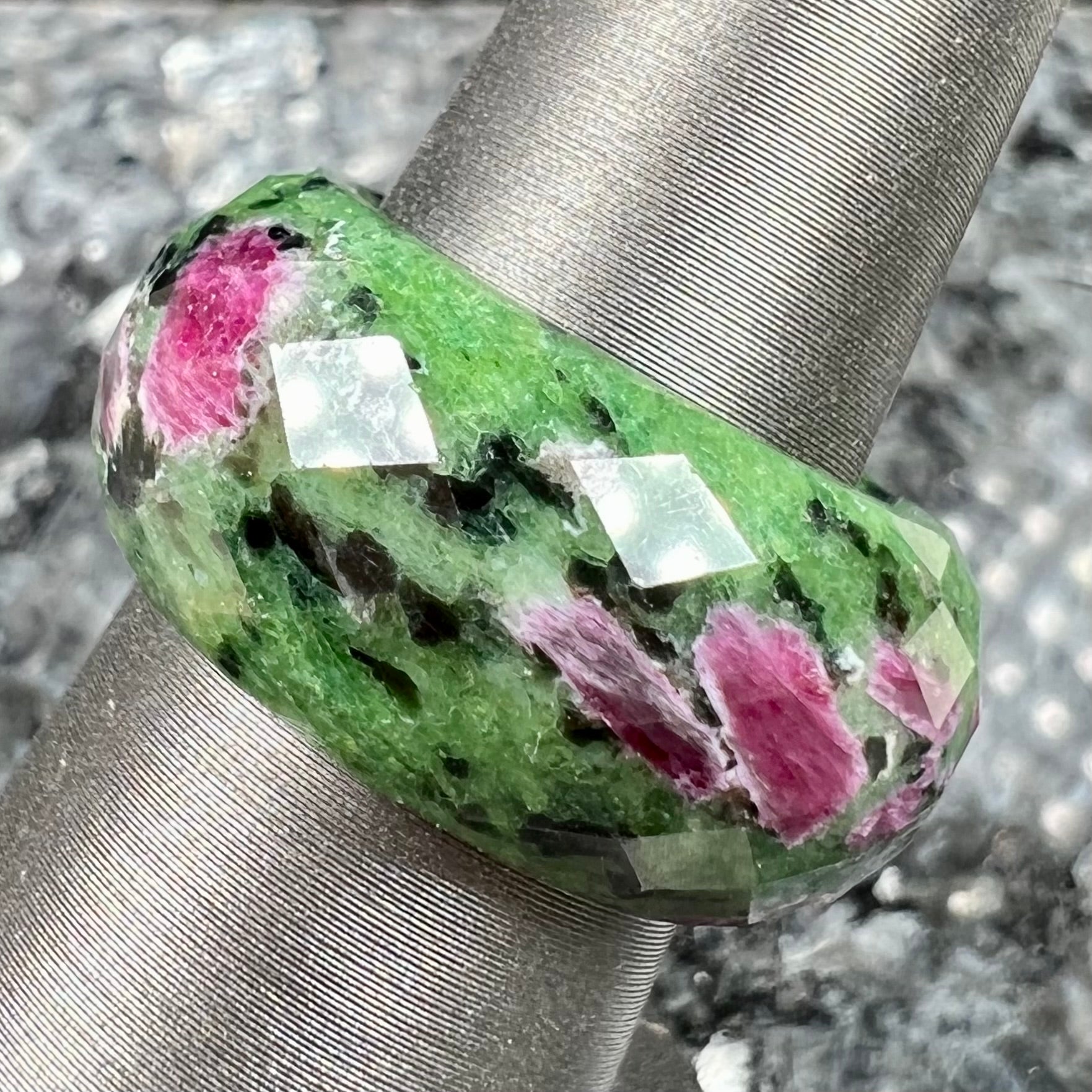 A faceted, carved stone ring made form ruby in zoisite.