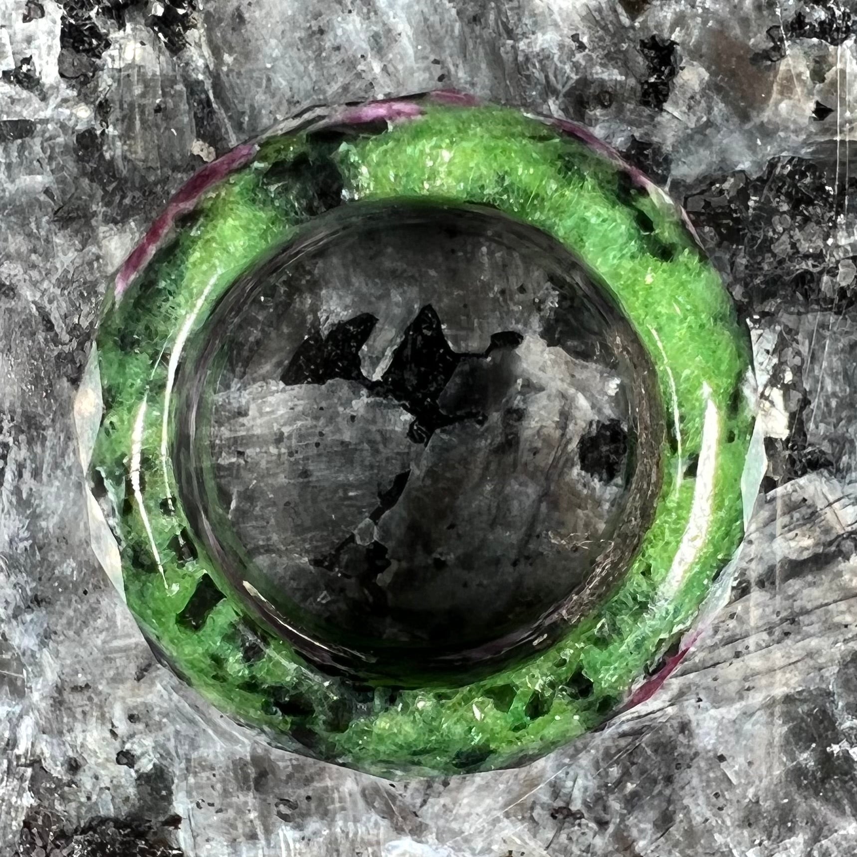 A faceted, carved stone ring made form ruby in zoisite.