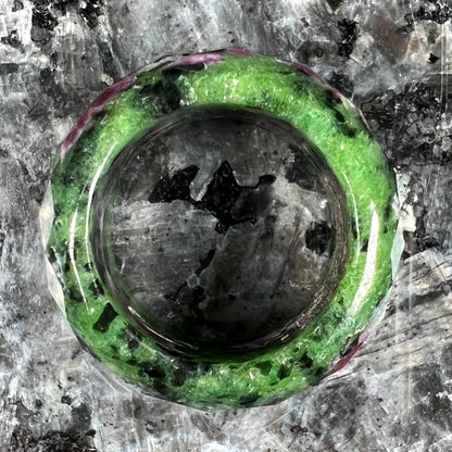 A faceted, carved stone ring made form ruby in zoisite.