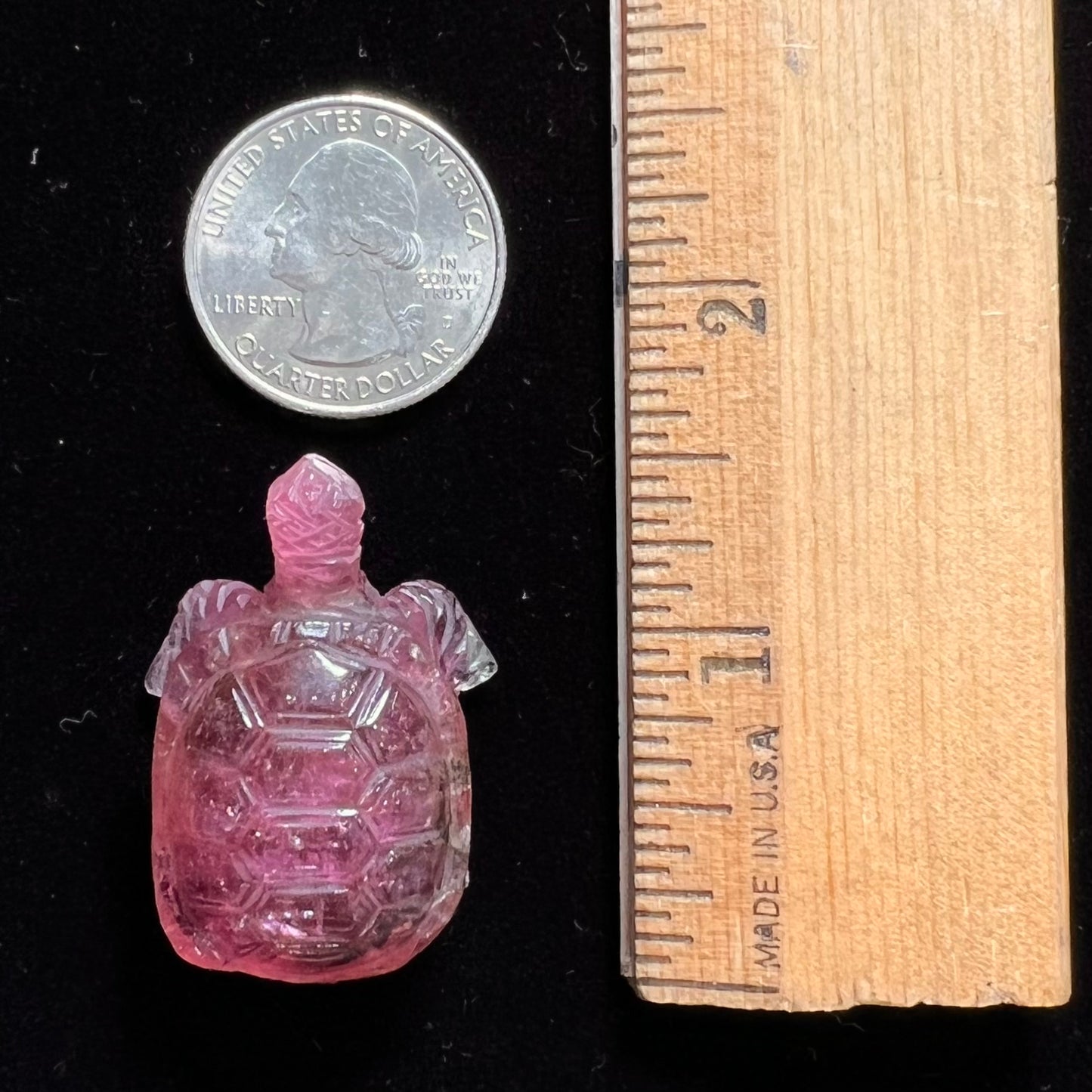 A crystal turtle carved from a pink tourmaline stone.