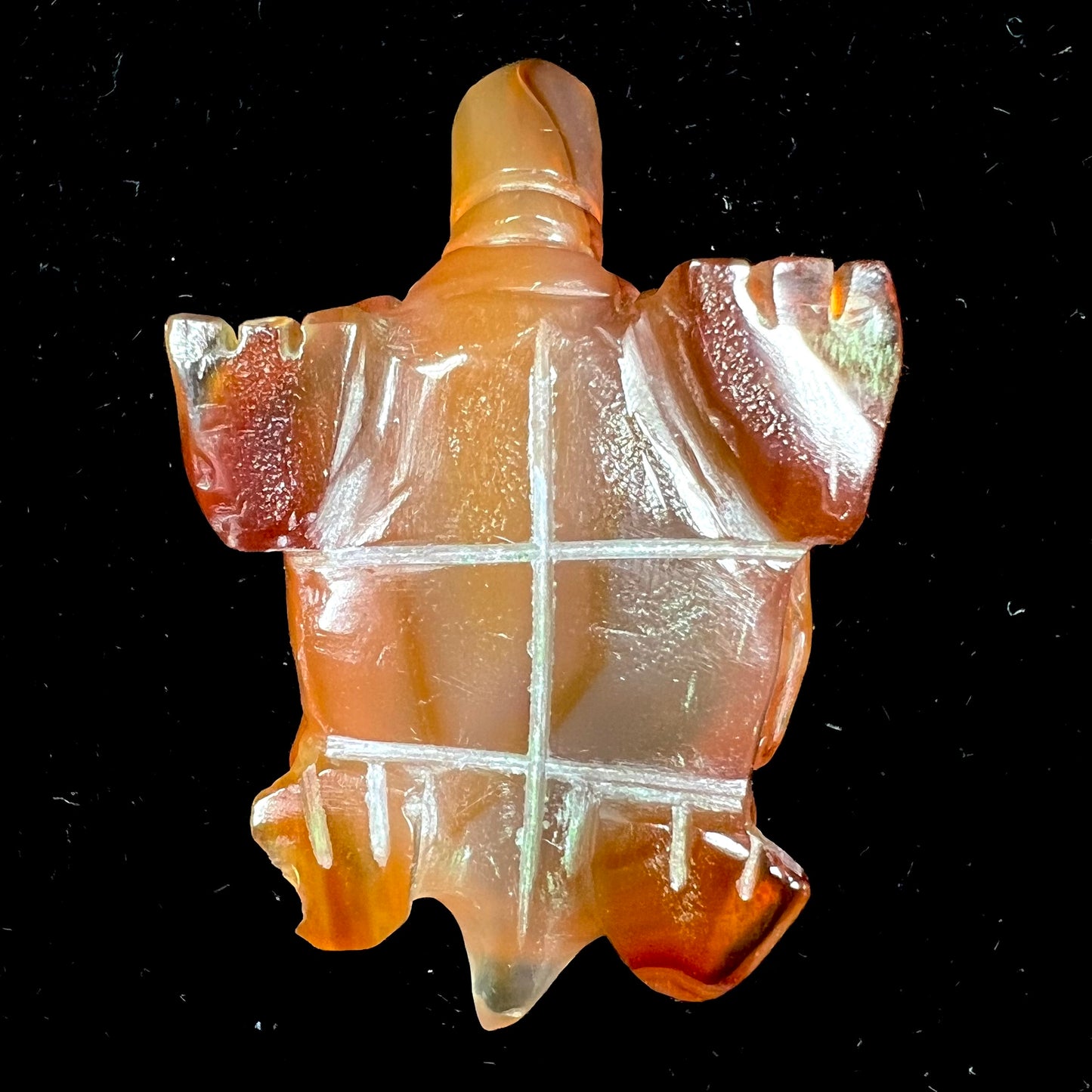A stone turtle carved from orange carnelian agate.