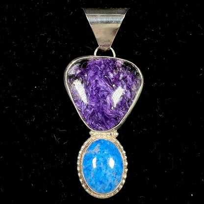A sterling silver pendant set with polished charoite and lapis lazuli stones, hand signed "KK" by the artist.