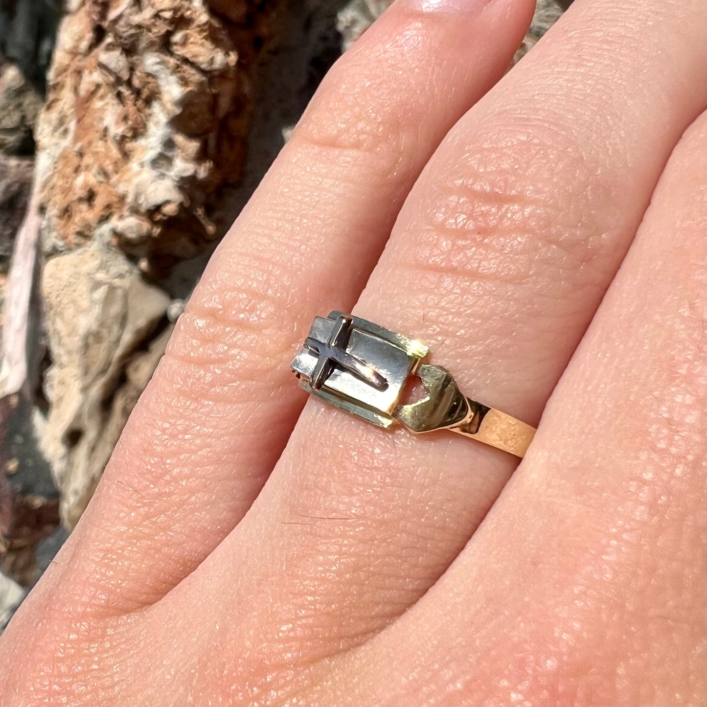 A tricolor gold cross ring handmade from rose, white, and yellow gold.