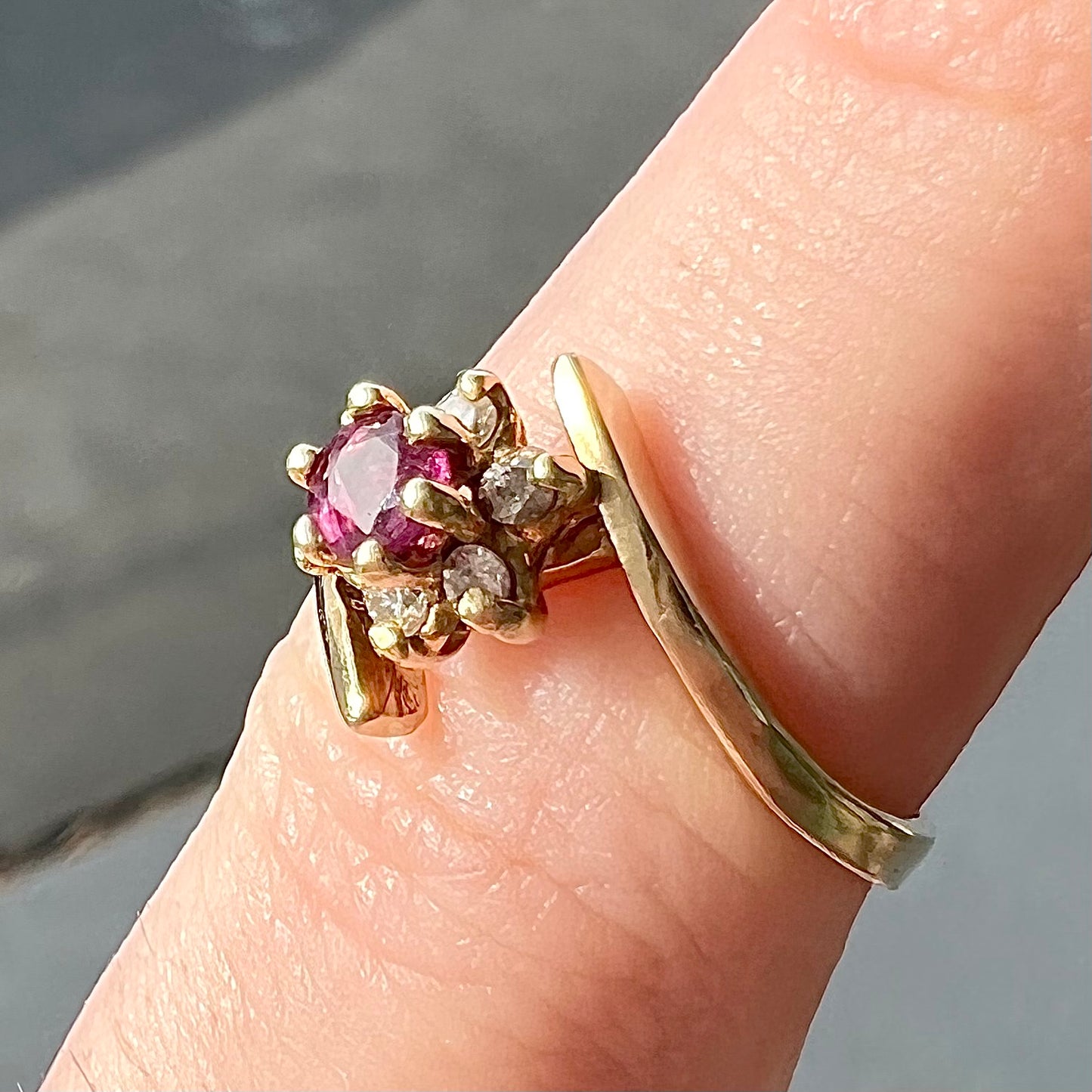 Custom twisted shank ruby and diamond halo yellow gold ring.