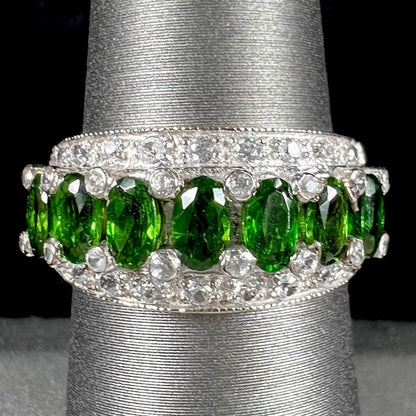 A ladies' two-tone white and yellow gold ring set withseven oval cut chrome diopside stones and cubic zirconia accents.