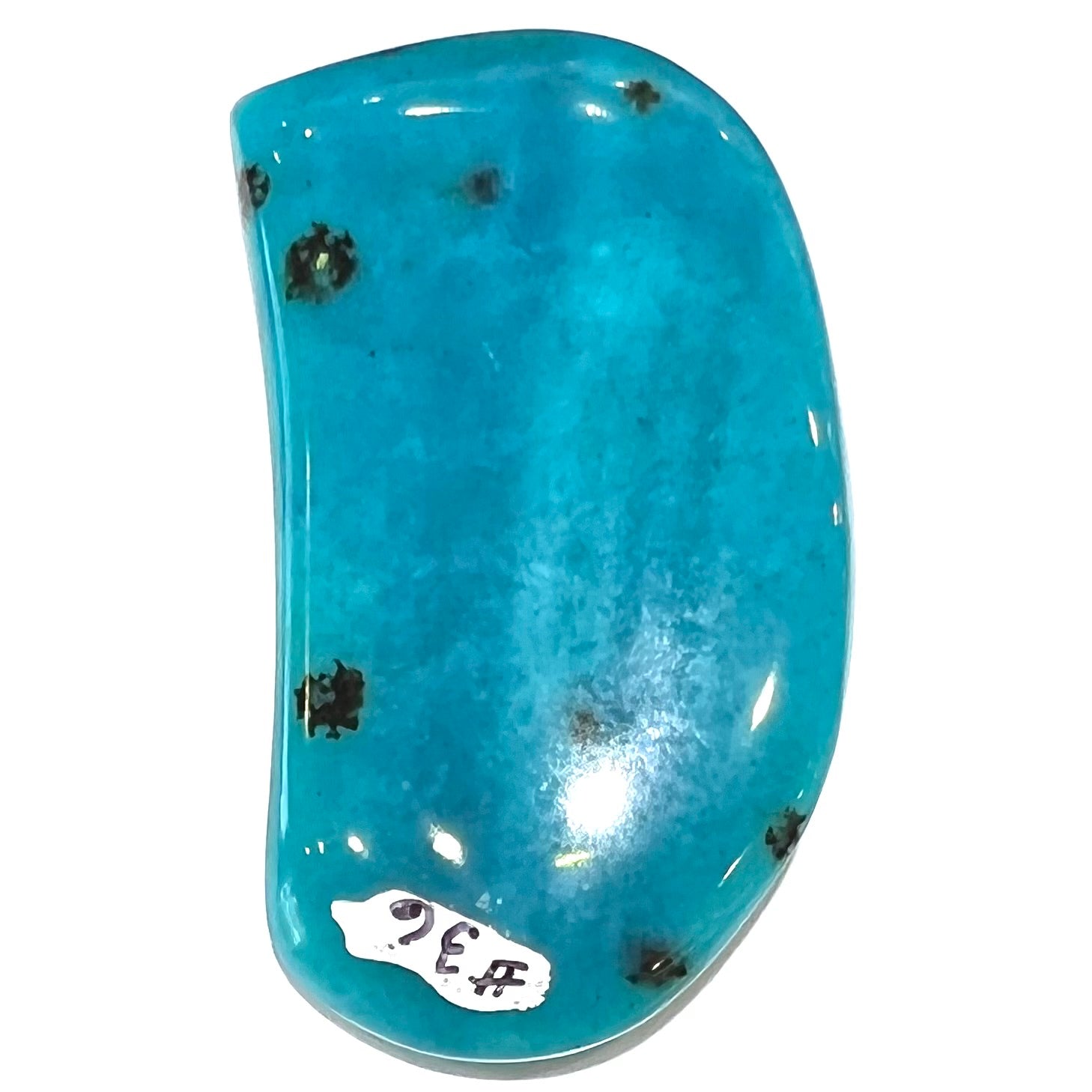 A loose, polished, spotted blue chrysocolla stone.