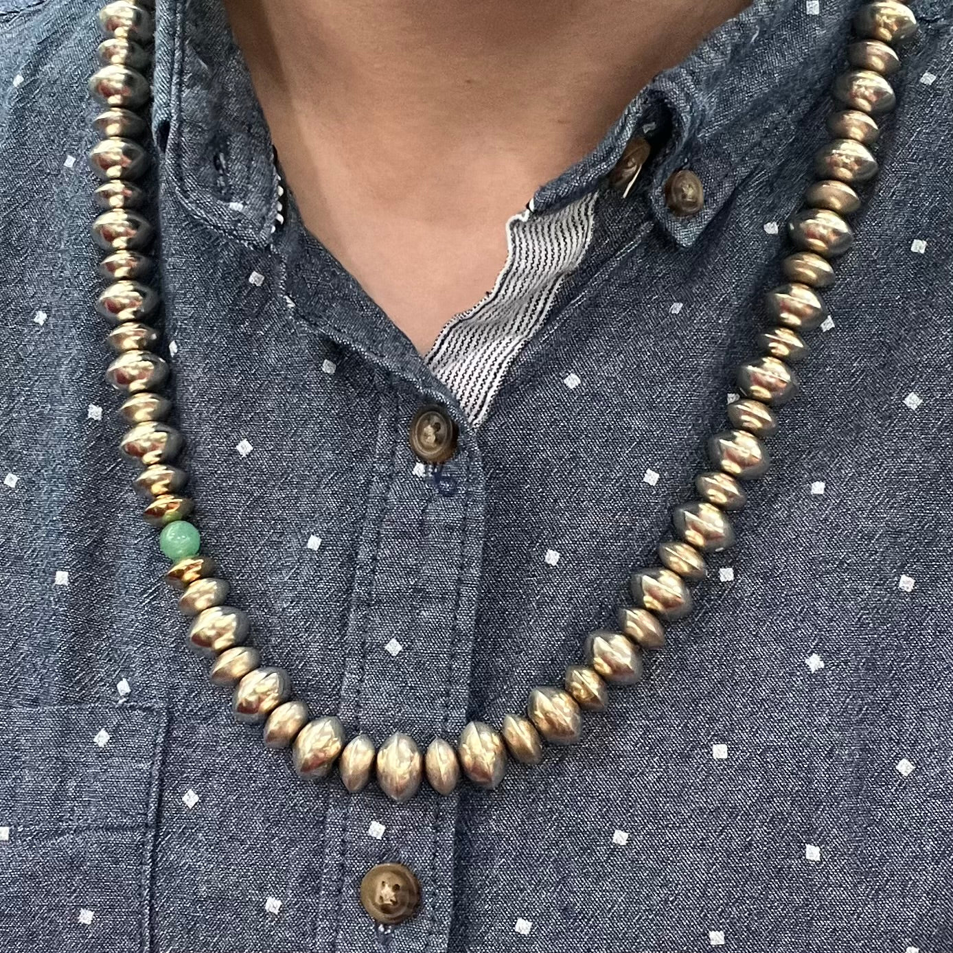 A silver, gold, and chrysoprase bead necklace handmade by Navajo artist, Alfred Joe.
