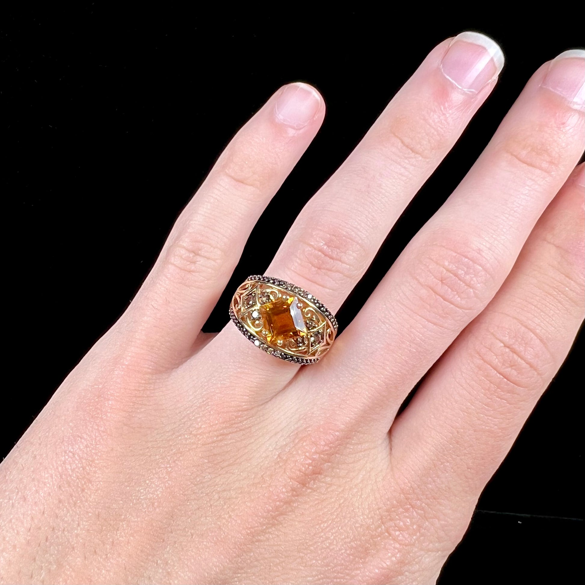 A square cut citrine and chocolate diamond filigree ring with andalusite accents.