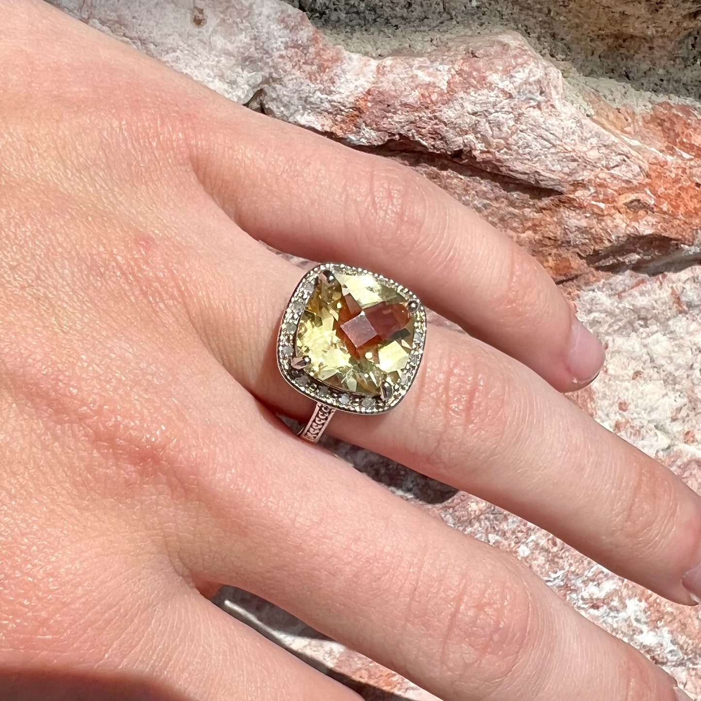 A silver cushion cut citrine and diamond halo ladies' ring.