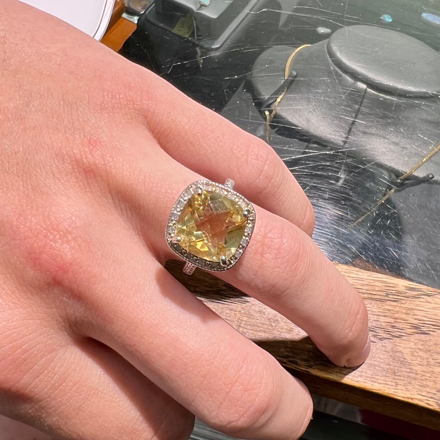 A silver cushion cut citrine and diamond halo ladies' ring.