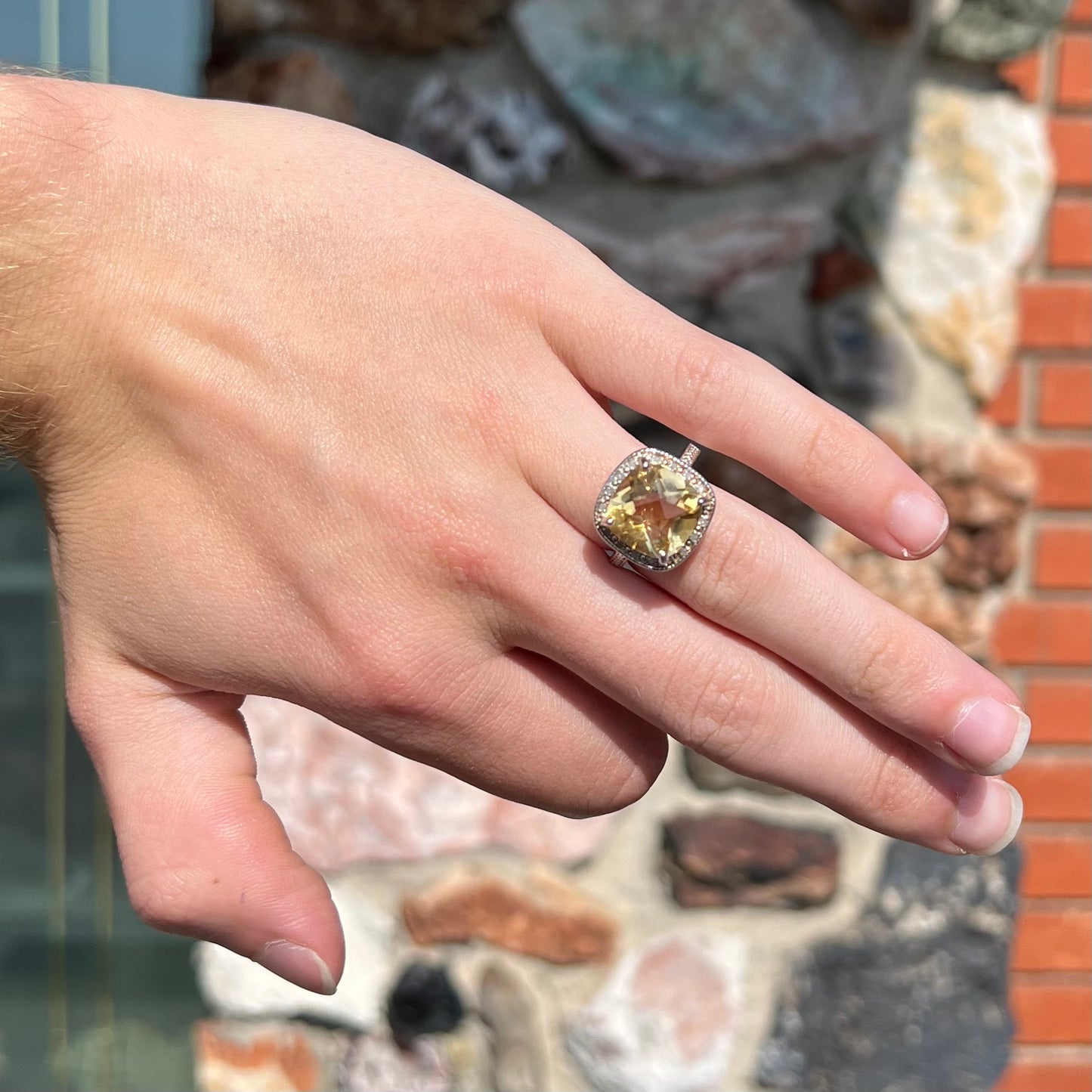 A silver cushion cut citrine and diamond halo ladies' ring.