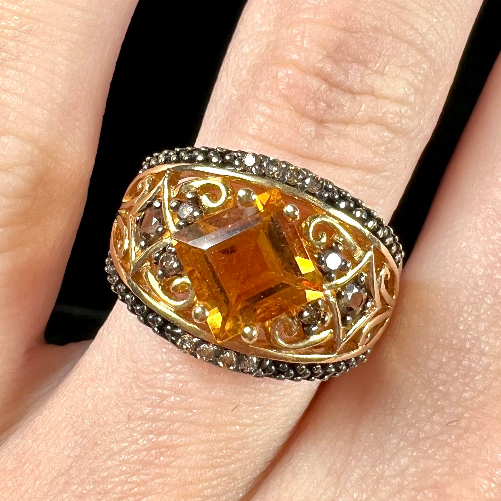 A square cut citrine and chocolate diamond filigree ring with andalusite accents.