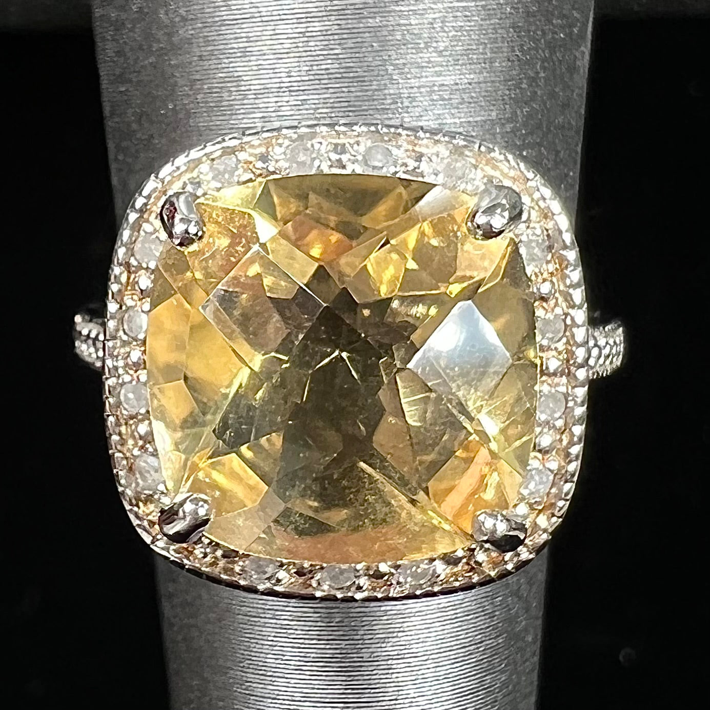 A silver cushion cut citrine and diamond halo ladies' ring.