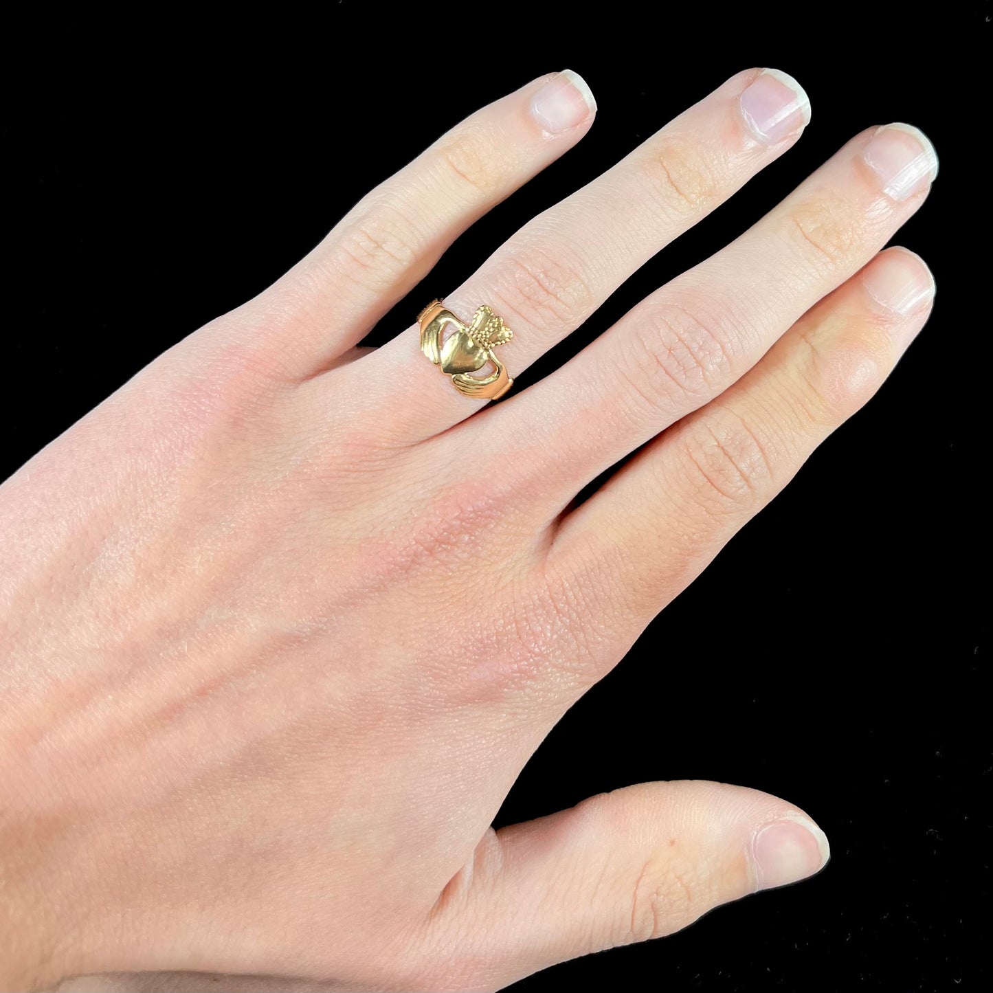A ladies' 14 karat yellow gold Irish claddagh ring stamped with the maker's hallmarks.