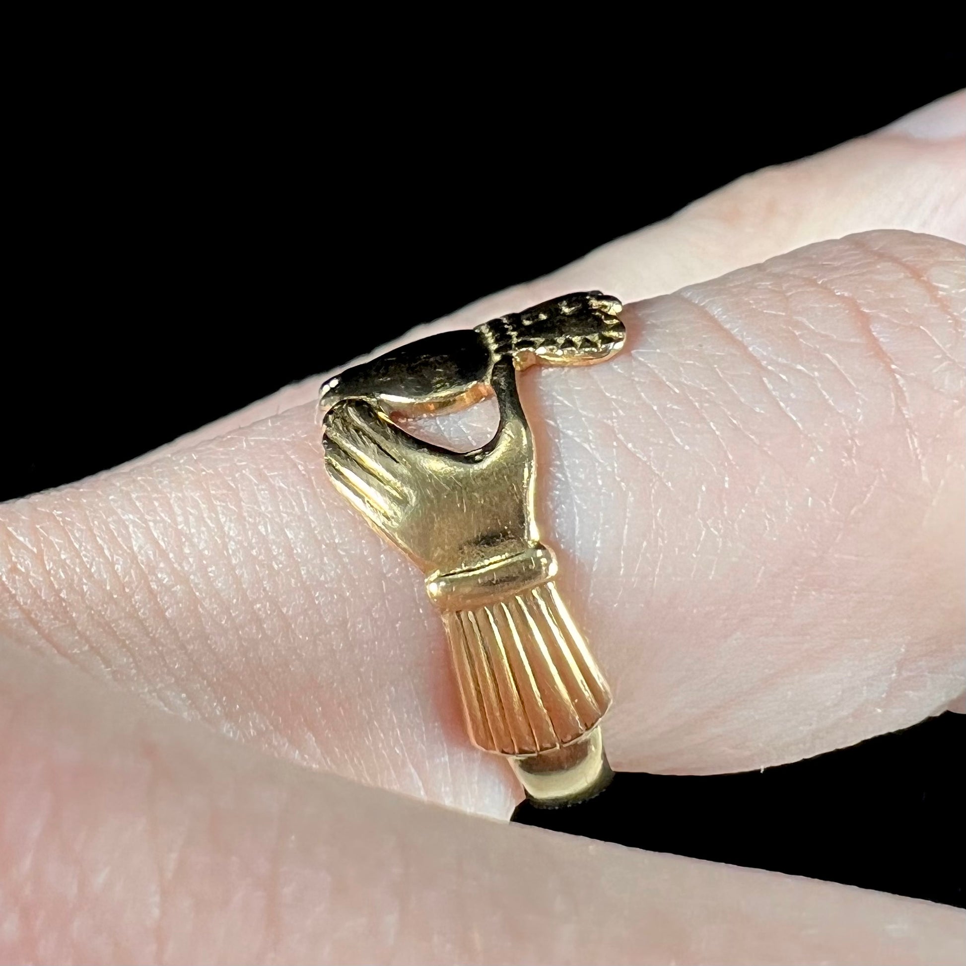 A ladies' 14 karat yellow gold Irish claddagh ring stamped with the maker's hallmarks.