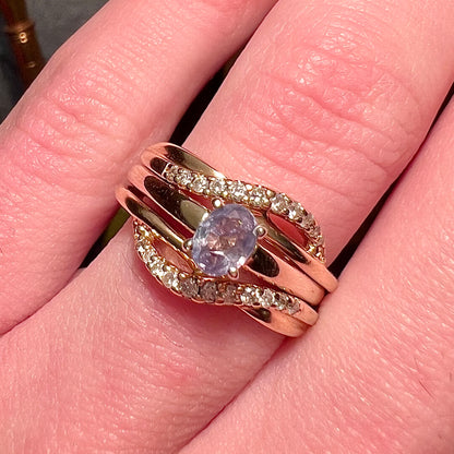 A natural 0.41ct alexandrite ring and ring guard set pave-set with diamonds.