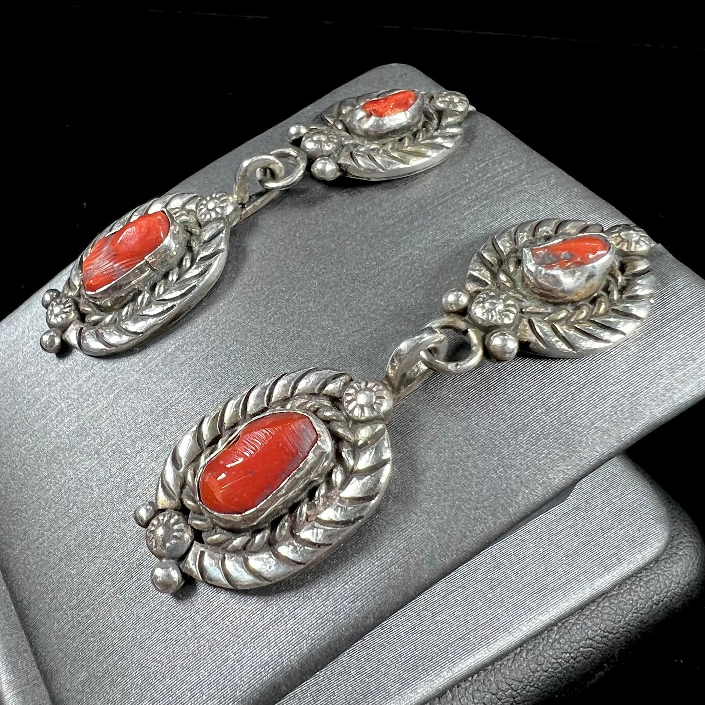 A pair of vintage coral branch dangle earrings handmade by Navajo artist, Delbert Chatter.