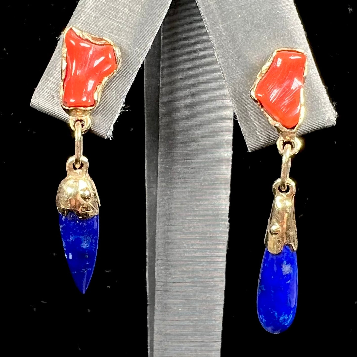 A pair of Navajo-handmade yellow gold dangle earrings set with lapis lazuli and polished coral branches.