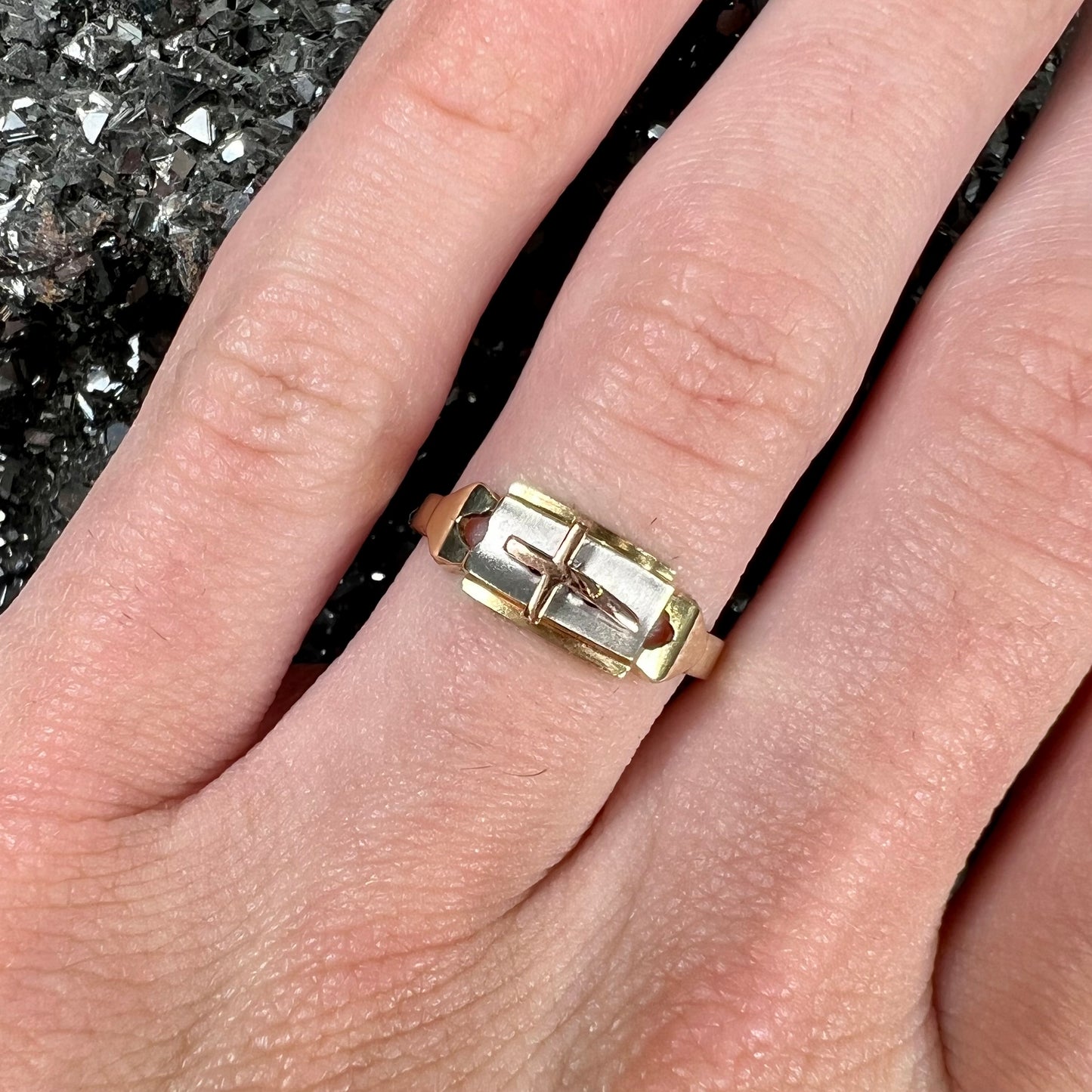 A tricolor gold cross ring handmade from rose, white, and yellow gold.