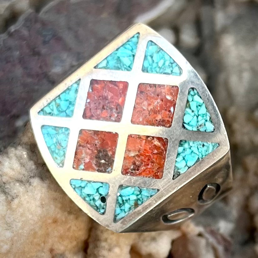 A sterling silver ring inlaid with crushed blue turquoise and crushed red coral.