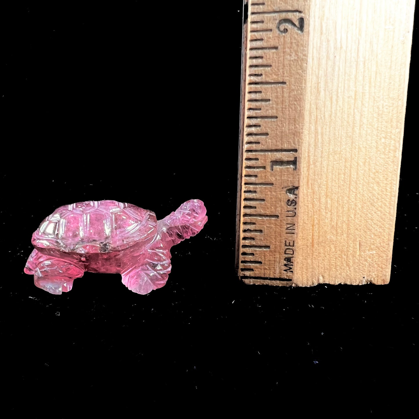 A crystal turtle carved from a pink tourmaline stone.