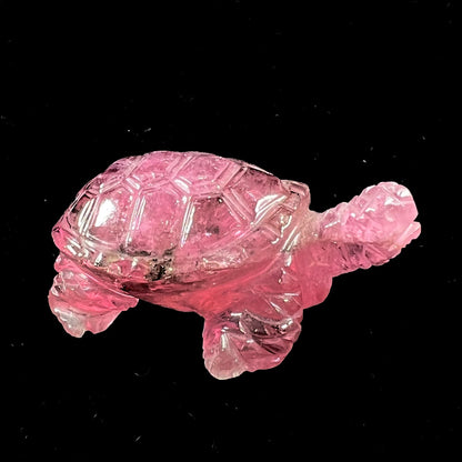 A crystal turtle carved from a pink tourmaline stone.