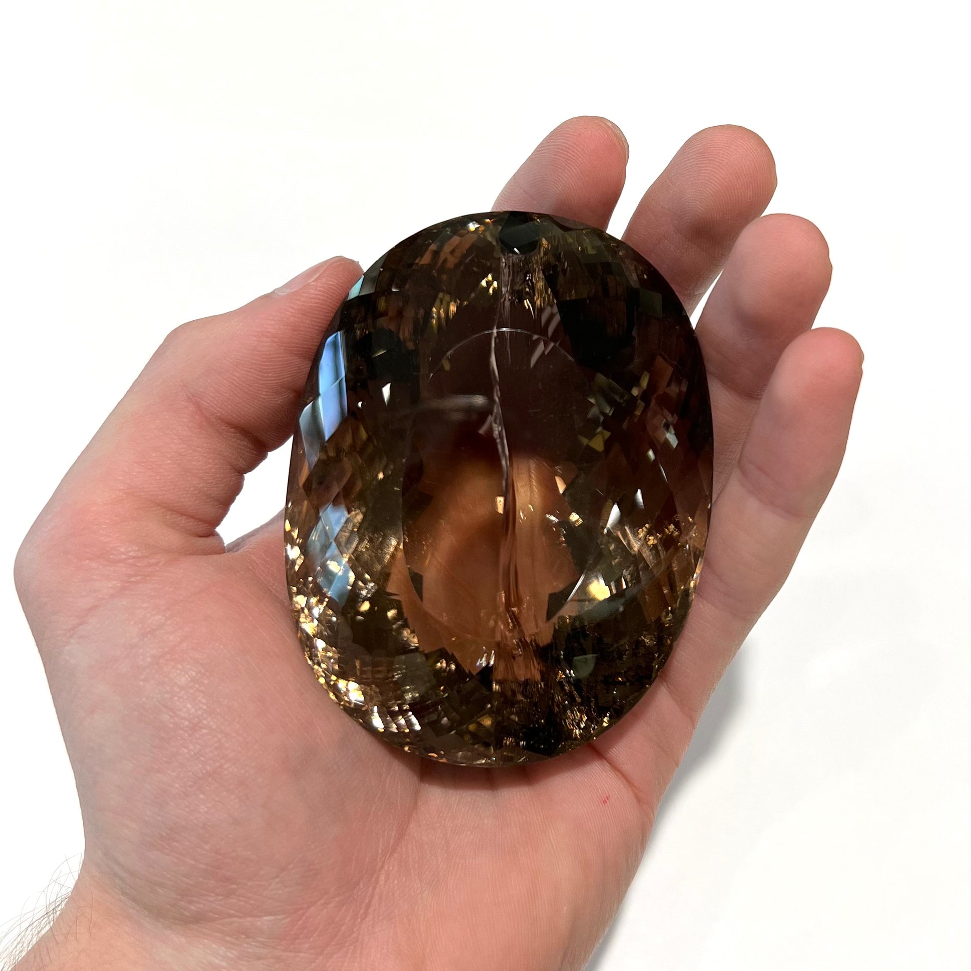 A loose, 1400+ carat smoky quartz gemstone.  The stone has a fracture that runs throughout the stone to the table.