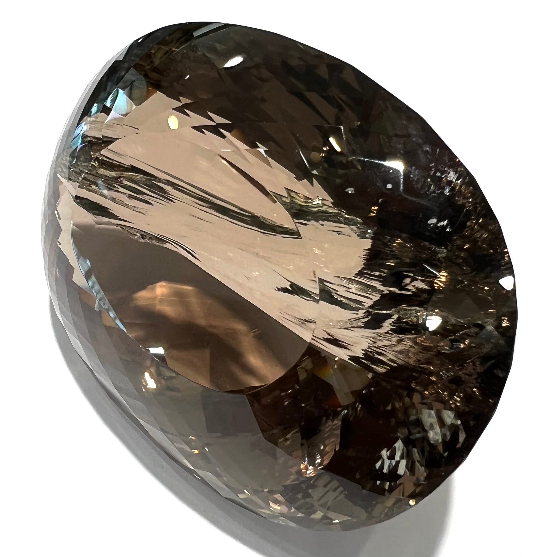A loose, 1400+ carat smoky quartz gemstone.  The stone has a fracture that runs throughout the stone to the table.