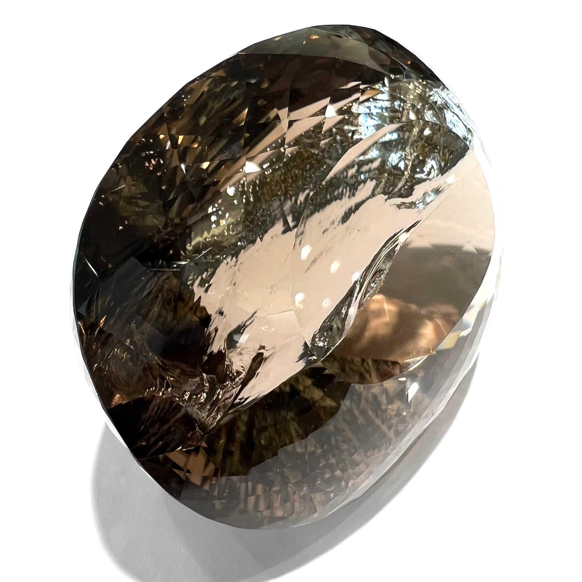A loose, 1400+ carat smoky quartz gemstone.  The stone has a fracture that runs throughout the stone to the table.