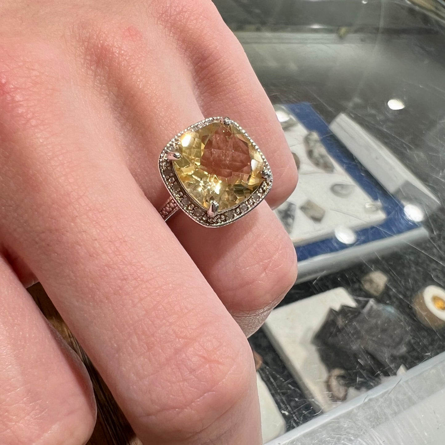 A silver cushion cut citrine and diamond halo ladies' ring.