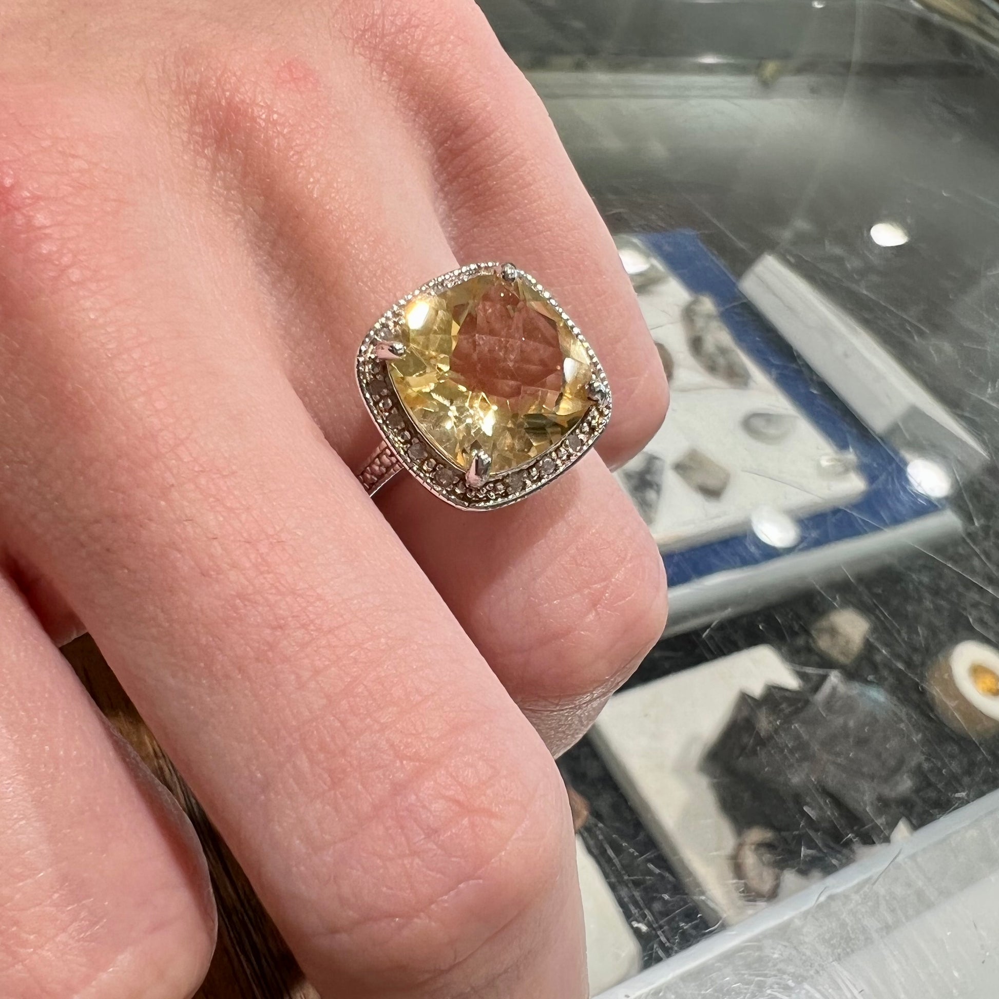 A silver cushion cut citrine and diamond halo ladies' ring.