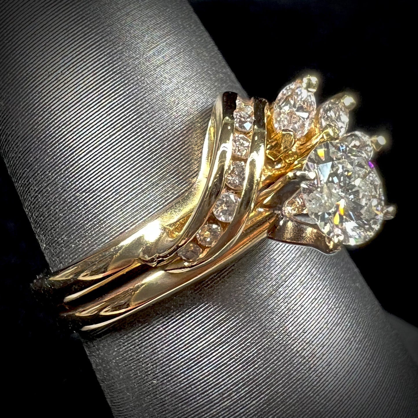 A ladies' diamond wedding set that has been soldered together in yellow gold.  There are round and marquise cut diamonds.