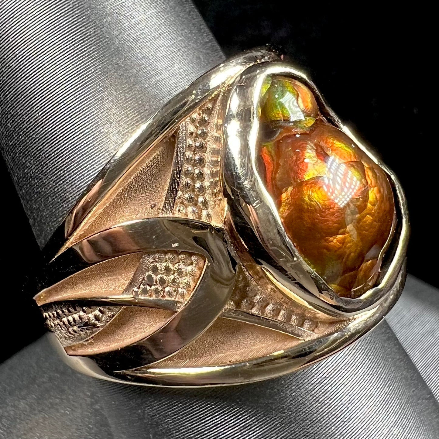 A men's 14kt yellow gold Mexican fire agate ring.