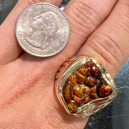 A men's custom fire agate solitaire ring cast in yellow gold.