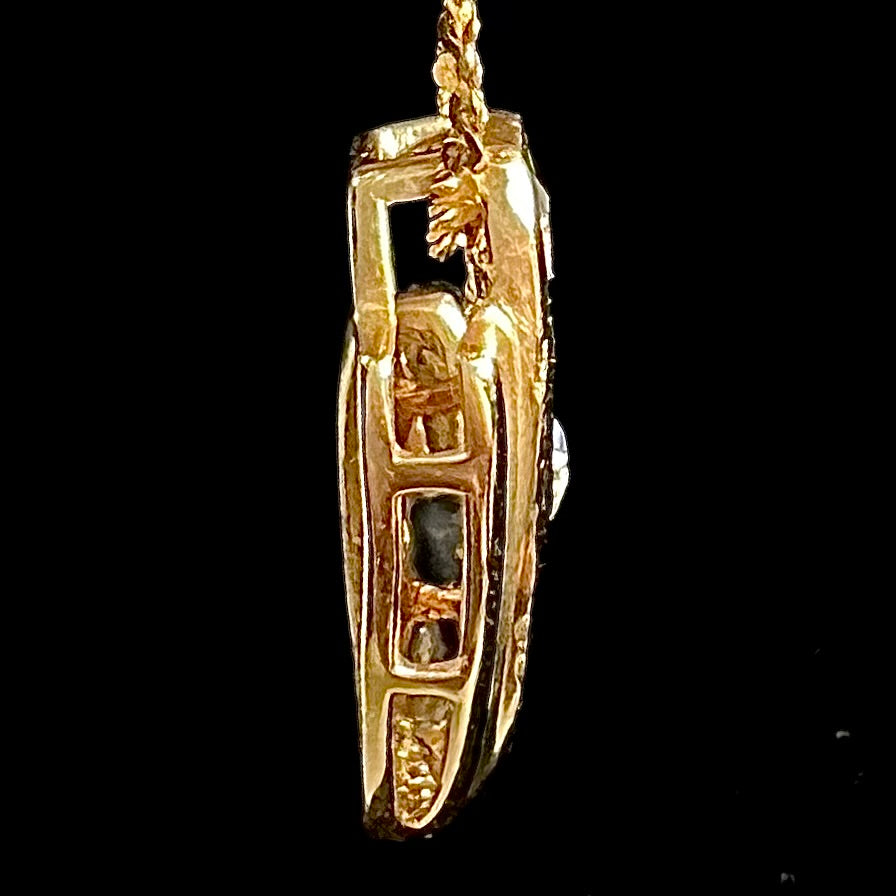 A Lightning Ridge black crystal opal necklace set with blue tanzanite in yellow gold.  Gold chain not included.
