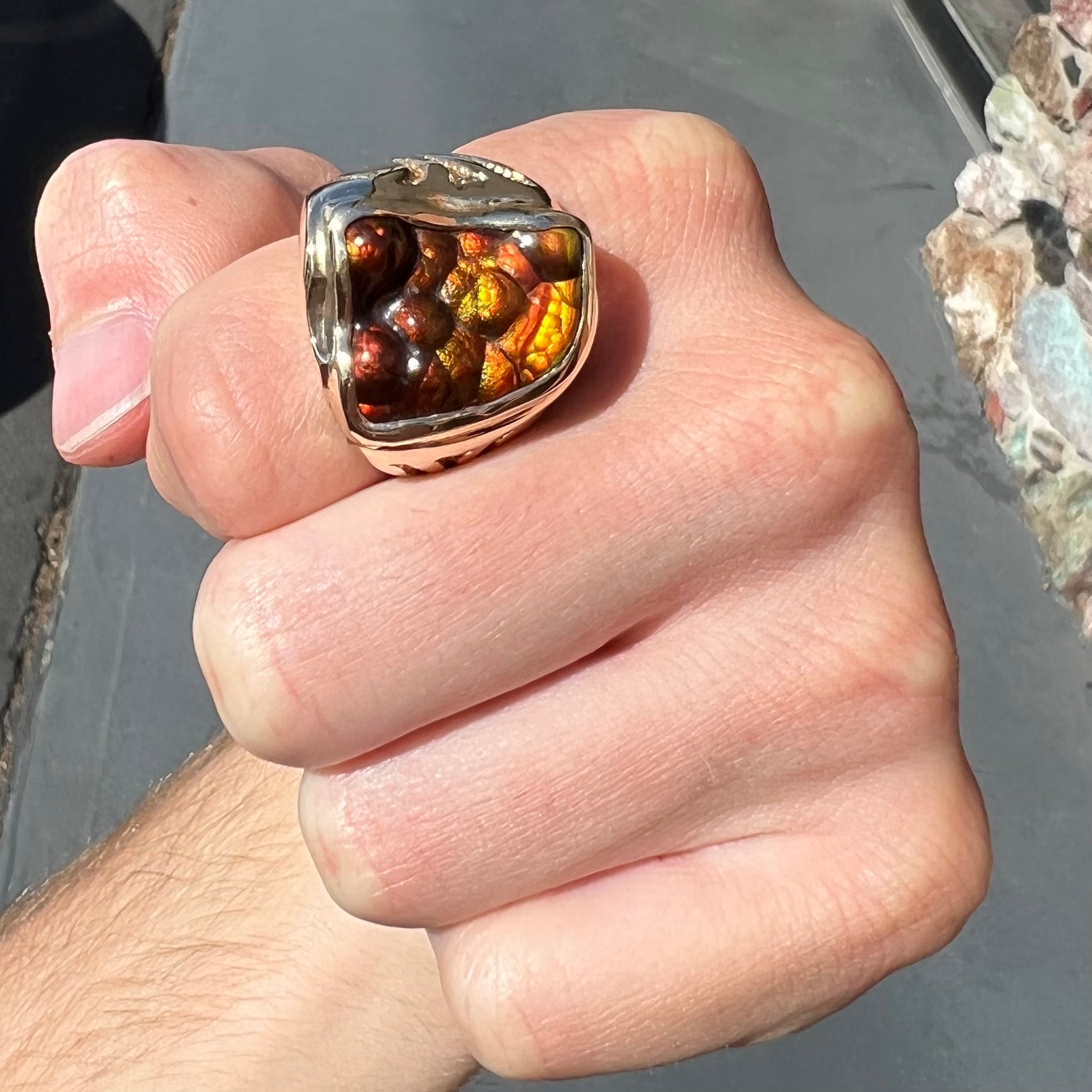 A men's custom fire agate solitaire ring cast in yellow gold.