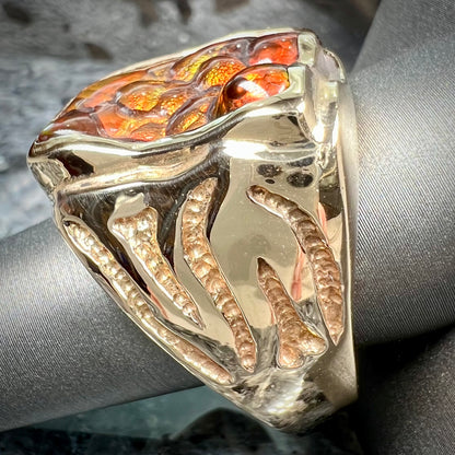 A men's custom fire agate solitaire ring cast in yellow gold.