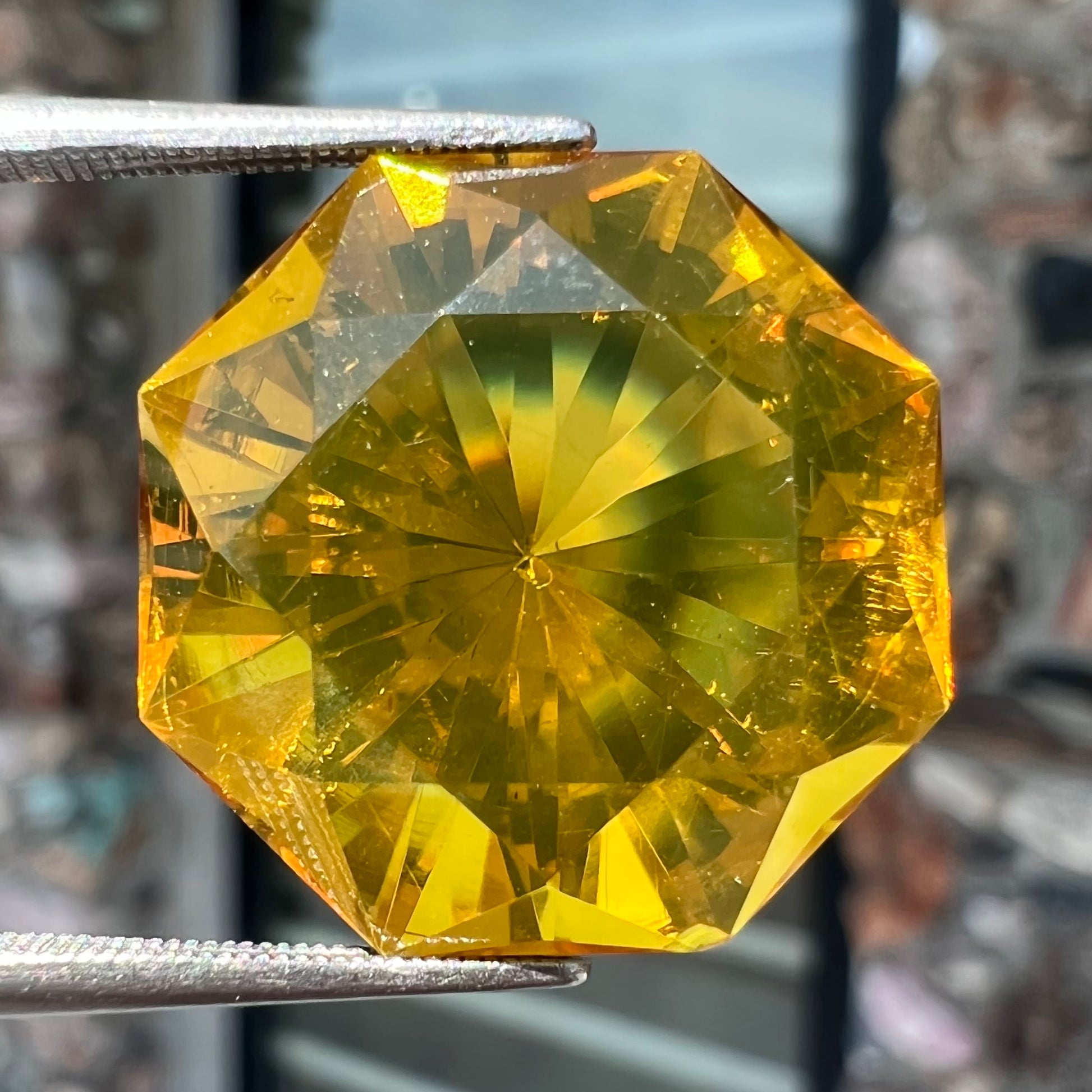 A loose, faceted octagonal cut golden amber stone.  There are no bug inclusions visible.