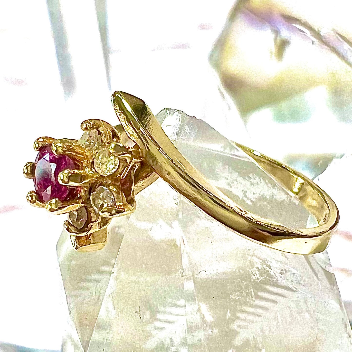 Custom twisted shank ruby and diamond halo yellow gold ring.