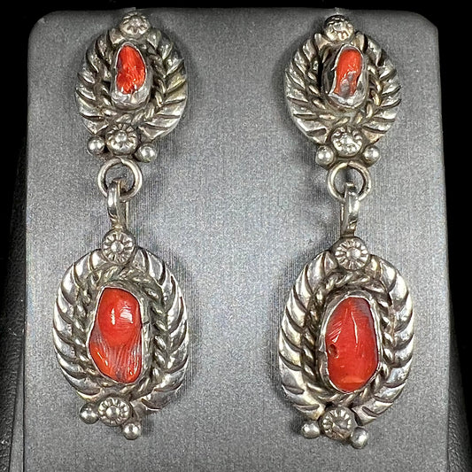 A pair of vintage coral branch dangle earrings handmade by Navajo artist, Delbert Chatter.