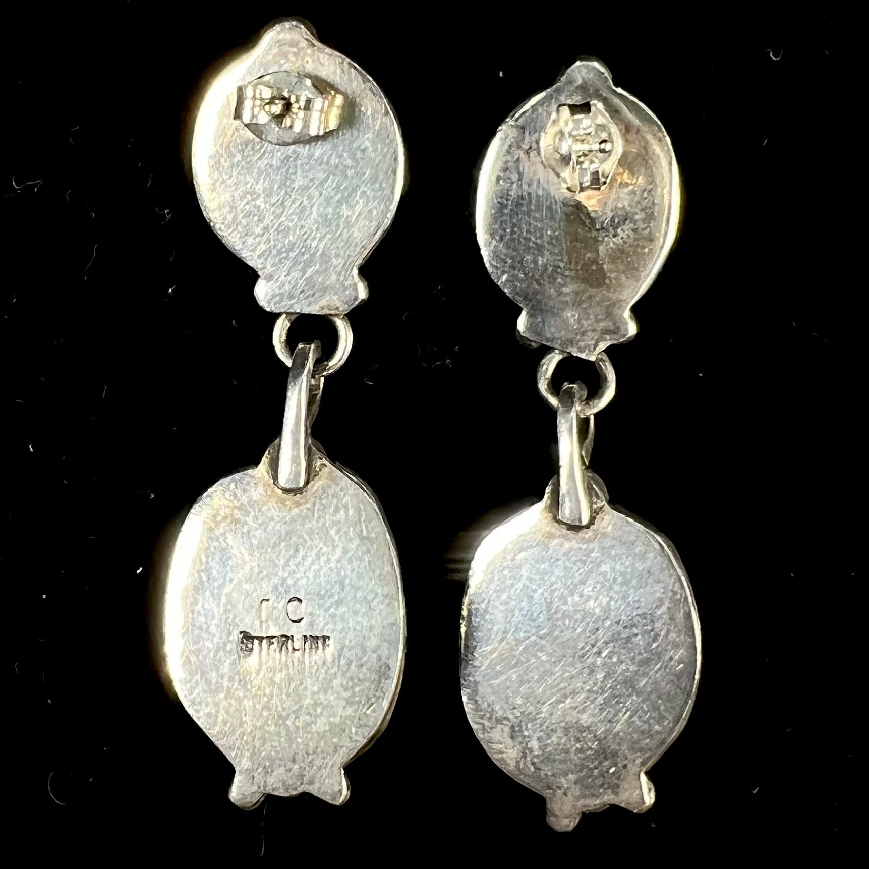 A pair of vintage coral branch dangle earrings handmade by Navajo artist, Delbert Chatter.