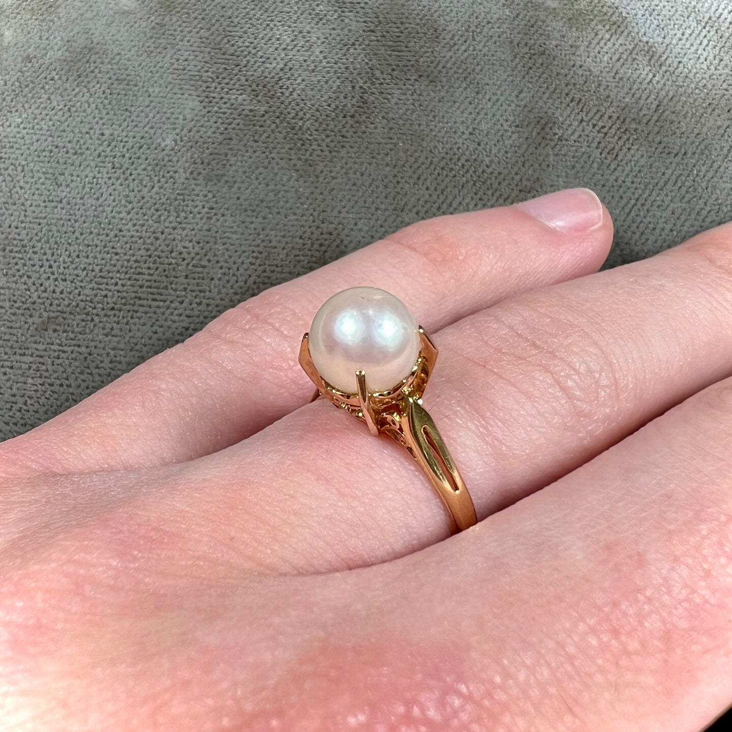 Round white pearl with pink overtones set in a vintage 18k yellow gold ring.